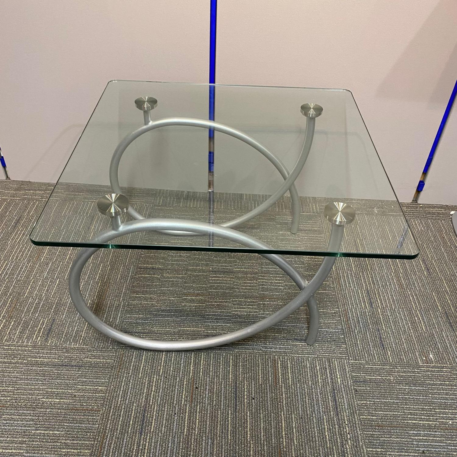 Second Hand Glass top reception table with chrome loop legs