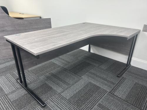 Used Crescent Desk, 1800mm Width x 1200mm Depth - Black Legs & Grey Oak Finish. 1 Right-Hand In Stock