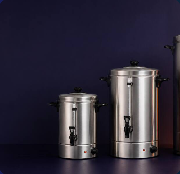 Two Burco stainless steel manual-fill water boilers with black taps and side handles against a dark navy background