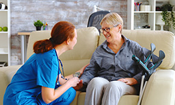 female nurse talking with old woman with alzheimer nursing home