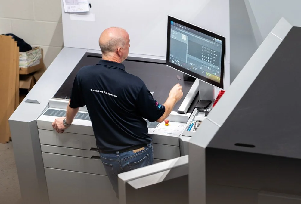 BSG employees working on the printer