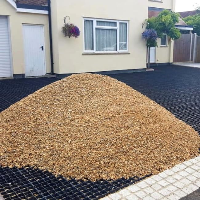 gravel being spread for driveway installation