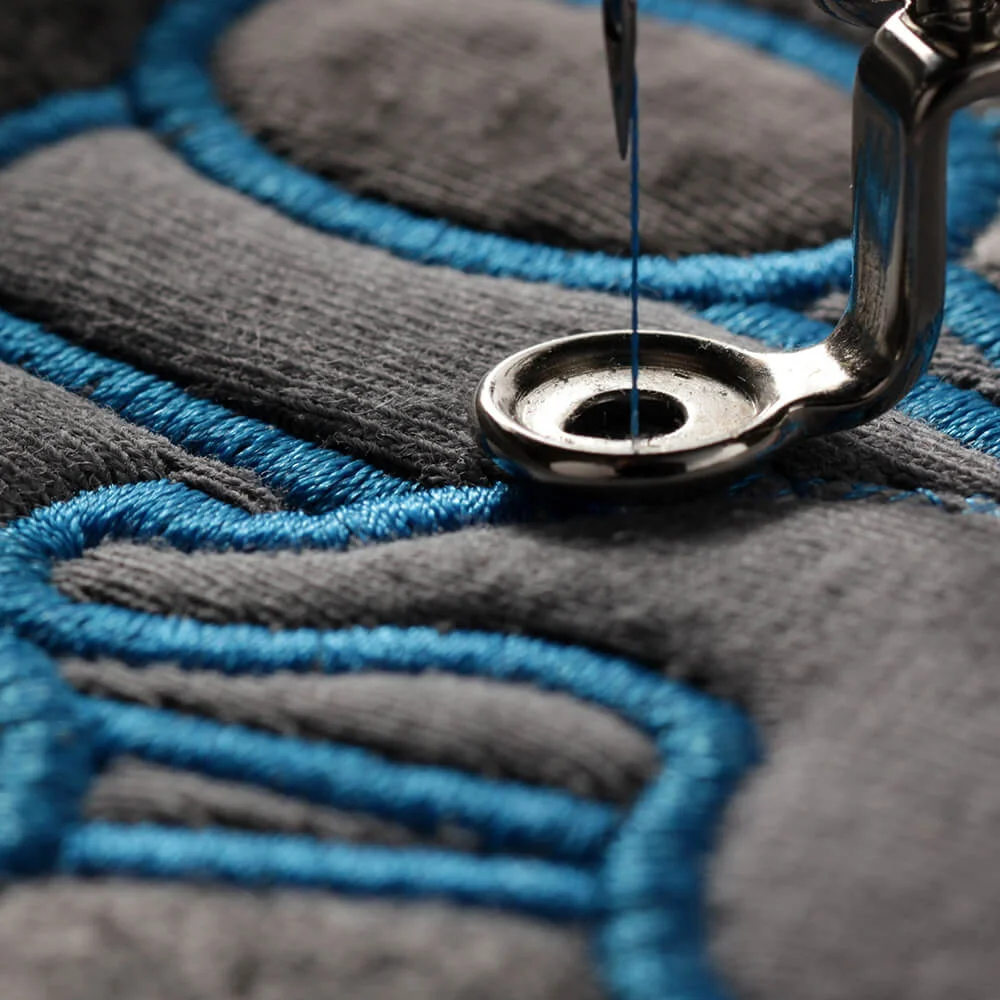 Close-up of embroidered logo on durable workwear fabric